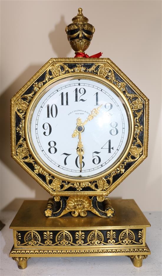 An early 20th century gilt and ebonised octagonal cased mantel clock retailed by Edward F. Caldwell & Co, New York, 13.75in.